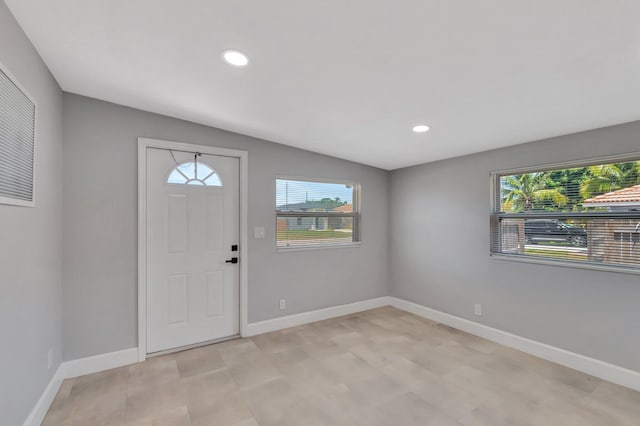 entrance foyer with healthy amount of natural light, baseboards, recessed lighting, and light wood-style flooring