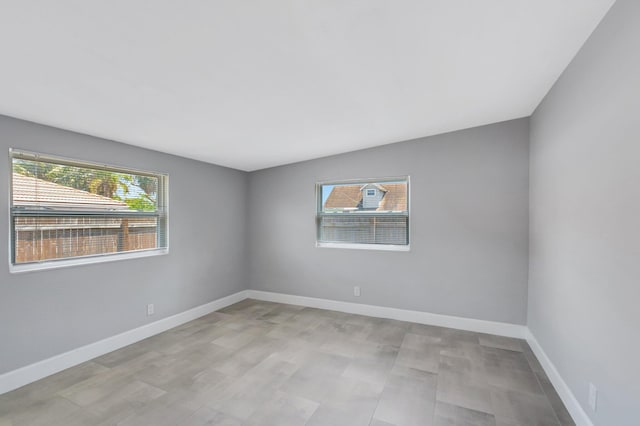 unfurnished room featuring baseboards