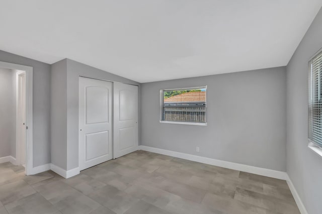 unfurnished bedroom featuring a closet and baseboards
