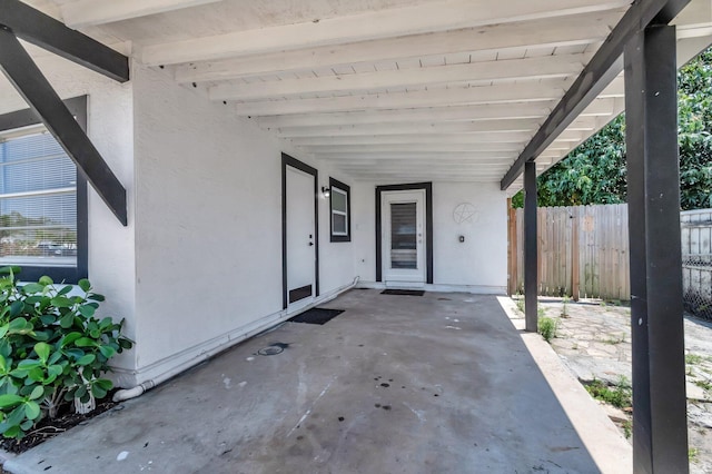view of patio / terrace featuring fence and an attached carport