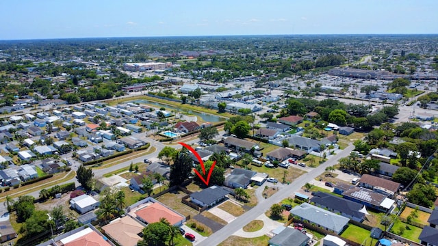 aerial view of property and surrounding area featuring nearby suburban area