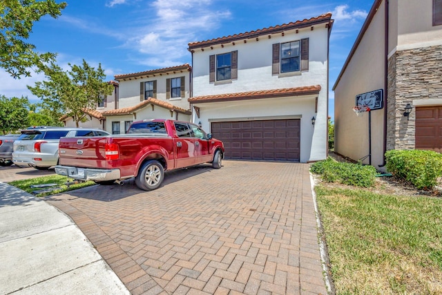 4006 Sequoia Pl W, Riviera Beach, FL 33410 - mediterranean / spanish home with stucco siding, a garage, decorative driveway, and a tile roof