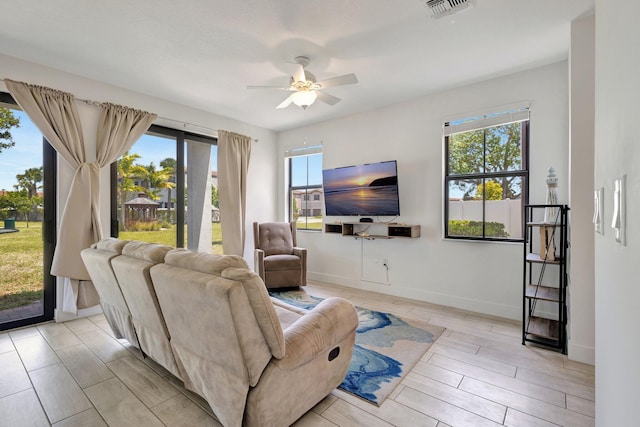 4006 Sequoia Pl W, Riviera Beach, FL 33410 - living room with healthy amount of natural light, ceiling fan, baseboards, and wood tiled floors