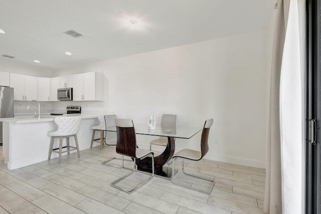 4006 Sequoia Pl W, Riviera Beach, FL 33410 - dining room featuring wood tiled floors, recessed lighting, and baseboards