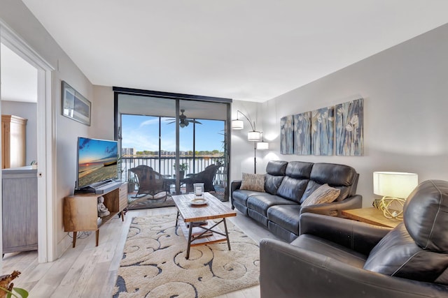 113 Lake Emerald Dr Unit 409, Oakland Park, FL 33309 - living area with wood finished floors, floor to ceiling windows, and ceiling fan