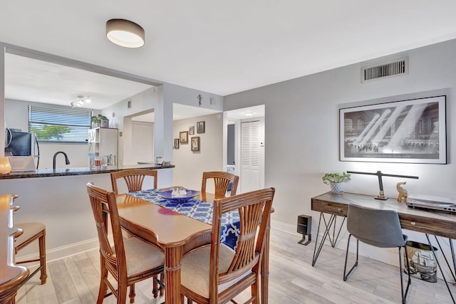 113 Lake Emerald Dr Unit 409, Oakland Park, FL 33309 - dining space featuring light wood-type flooring and baseboards