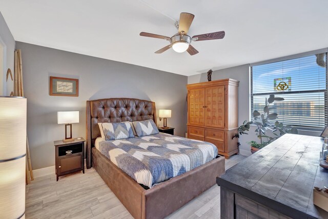 113 Lake Emerald Dr Unit 409, Oakland Park, FL 33309 - bedroom featuring light wood-type flooring, baseboards, and ceiling fan
