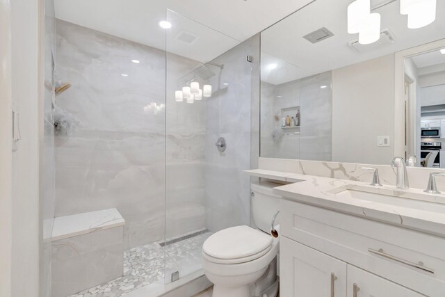 full bathroom with walk in shower, toilet, and vanity