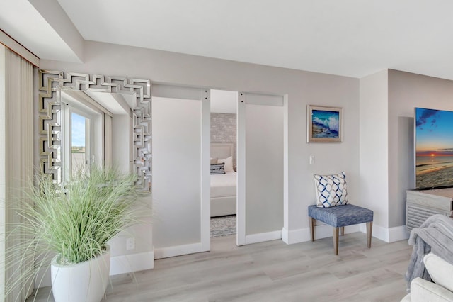 living area with light wood finished floors and baseboards