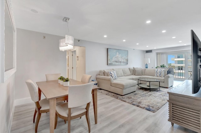 living room featuring light wood-style flooring, recessed lighting, and baseboards
