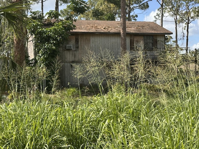 view of home's exterior with a shingled roof
