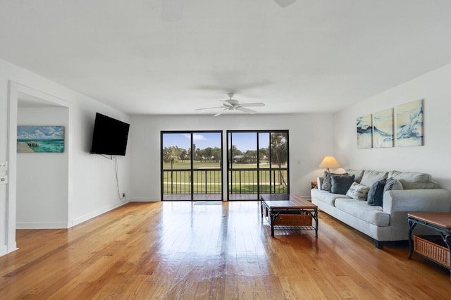 9109 SE Riverfront Ter Unit B, Jupiter, FL 33469 - living room with ceiling fan, light wood finished floors, and baseboards
