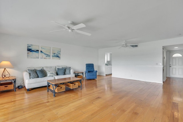 living area featuring a ceiling fan and light wood-type flooring
