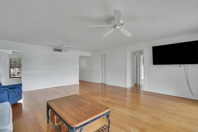 living area with a ceiling fan and light wood finished floors