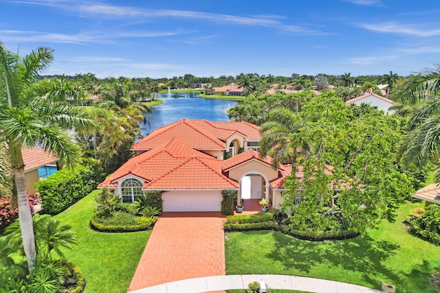 19262 Redberry Ct, Boca Raton, FL 33498 - view of front of home with a tiled roof, a garage, a water view, and a front lawn