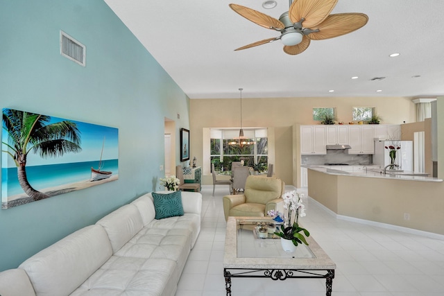 19262 Redberry Ct, Boca Raton, FL 33498 - living area with a chandelier, a high ceiling, ceiling fan, light tile patterned flooring, and recessed lighting