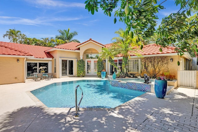 19262 Redberry Ct, Boca Raton, FL 33498 - view of pool featuring french doors, a patio, and a pool with connected hot tub