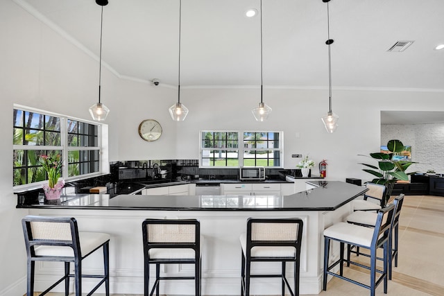 19262 Redberry Ct, Boca Raton, FL 33498 - kitchen featuring a sink, appliances with stainless steel finishes, dark countertops, white cabinetry, and ornamental molding