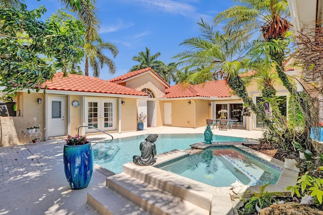 19262 Redberry Ct, Boca Raton, FL 33498 - view of swimming pool with french doors, a patio area, and a pool with connected hot tub