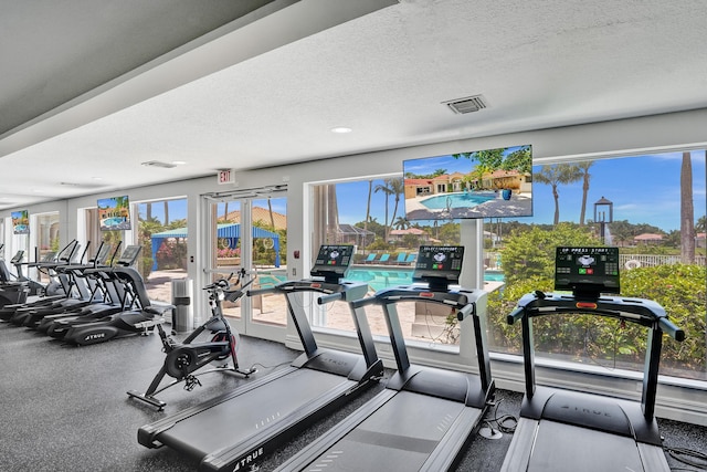 19262 Redberry Ct, Boca Raton, FL 33498 - workout area with healthy amount of natural light, a textured ceiling, and french doors