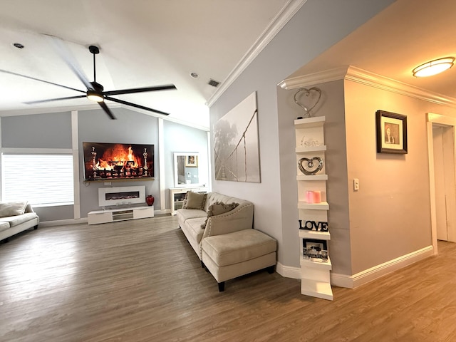 living area with crown molding, ceiling fan, wood finished floors, baseboards, and lofted ceiling