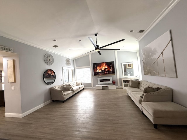 living area featuring ceiling fan, crown molding, baseboards, wood finished floors, and a fireplace