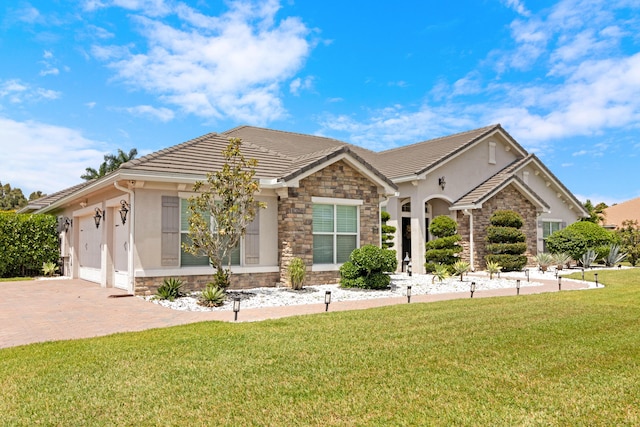 5351 N Sterling Ranch Cir, Davie, FL 33314 - single story home featuring stone siding, stucco siding, a front yard, decorative driveway, and a garage