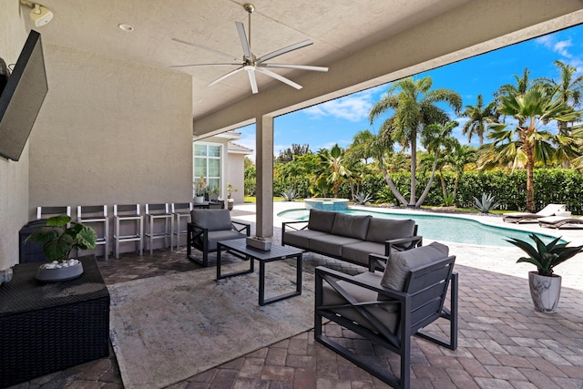 view of patio / terrace featuring outdoor lounge area, a ceiling fan, and an outdoor bar