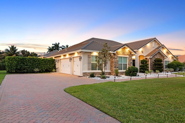 ranch-style house with stone siding, stucco siding, and a tile roof