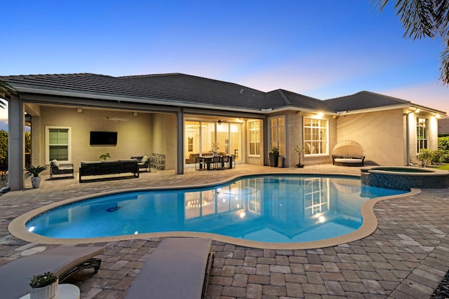 view of pool with a ceiling fan, a patio area, an outdoor living space, a pool with connected hot tub, and outdoor dining area