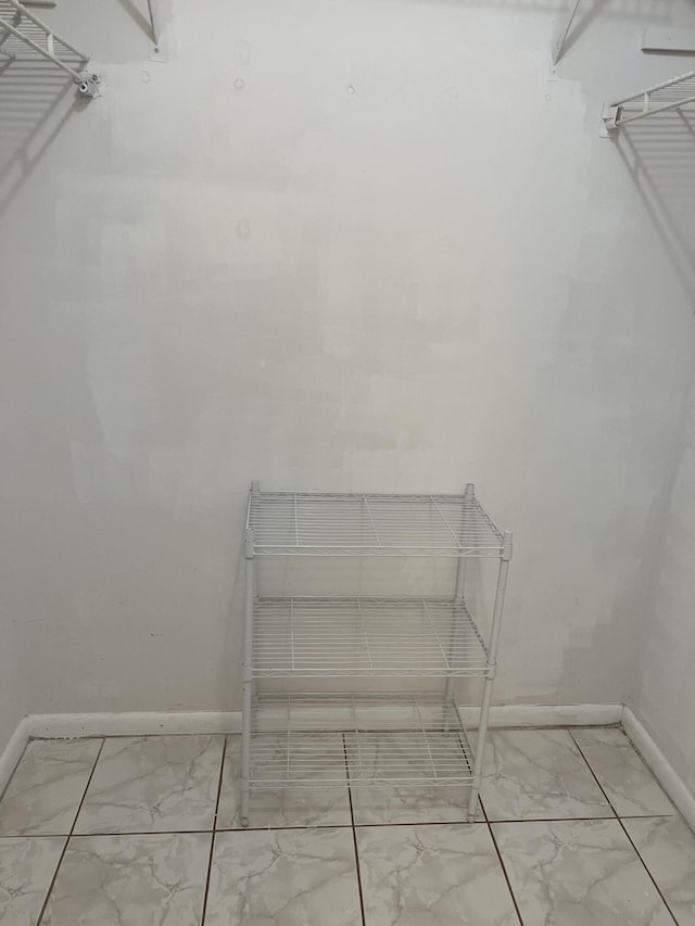 spacious closet with marble look tiles
