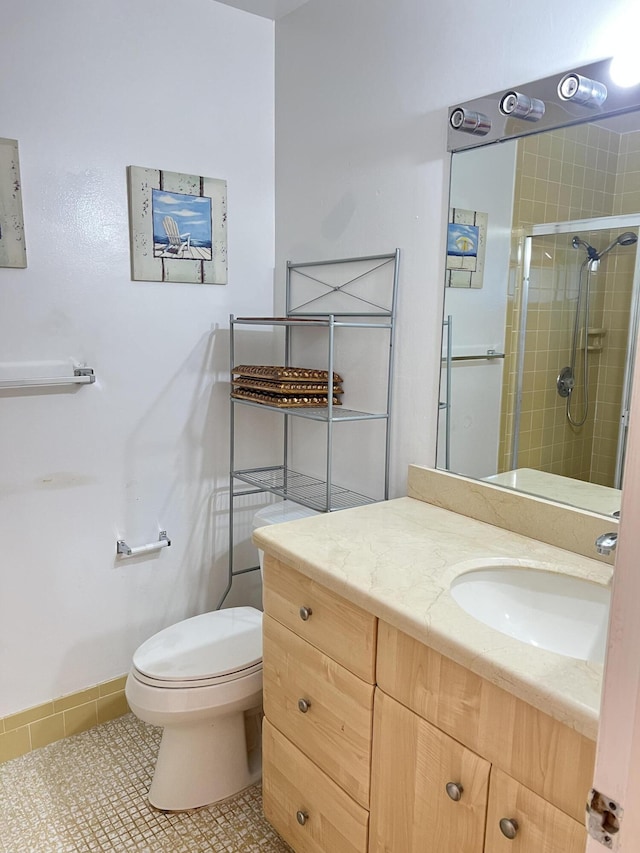full bath with a shower stall, toilet, tile patterned flooring, and vanity