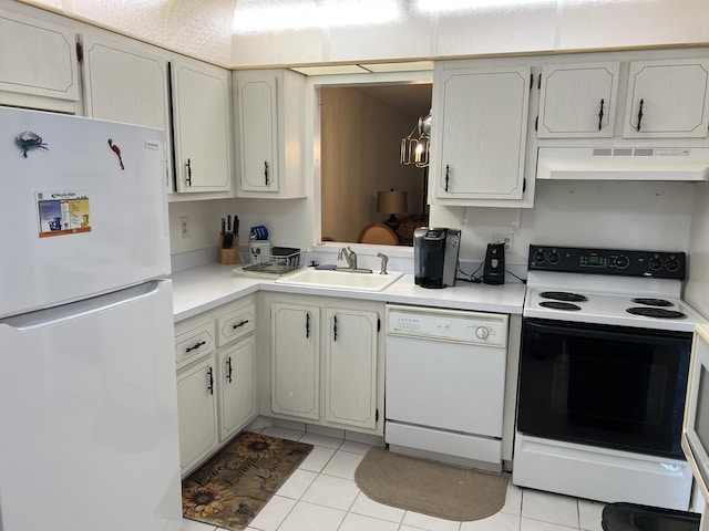 kitchen with white appliances, under cabinet range hood, a sink, and light countertops