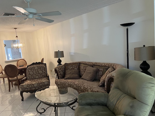 living area featuring a chandelier, a textured ceiling, and ceiling fan
