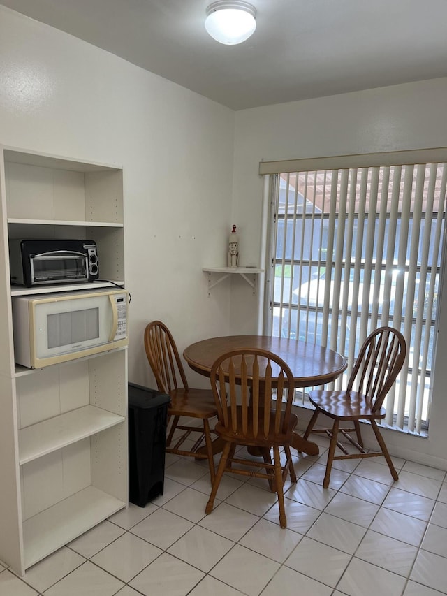 dining space featuring light tile patterned flooring