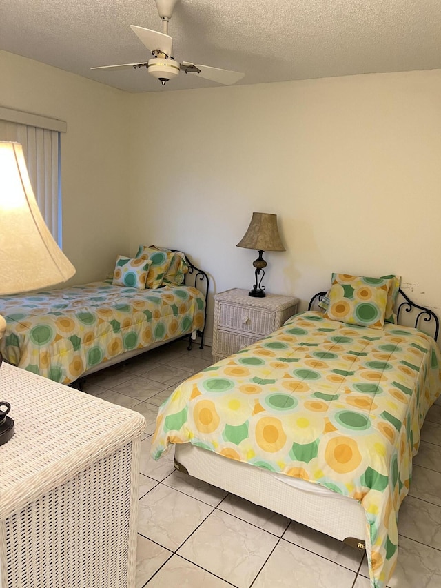 bedroom featuring a textured ceiling and a ceiling fan