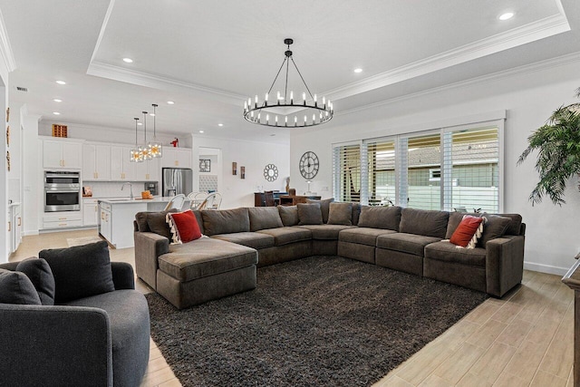 962 Castaway Ct, Loxahatchee, FL 33470 - living area with a chandelier, a tray ceiling, ornamental molding, light wood finished floors, and recessed lighting