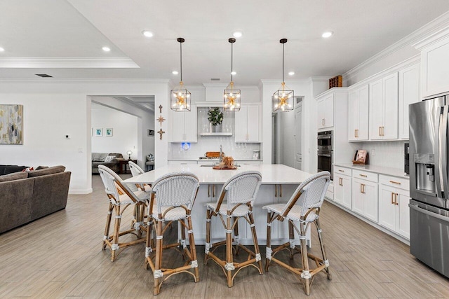 962 Castaway Ct, Loxahatchee, FL 33470 - kitchen featuring appliances with stainless steel finishes, ornamental molding, light countertops, backsplash, and white cabinets