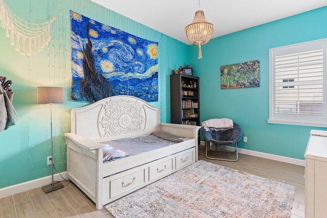 962 Castaway Ct, Loxahatchee, FL 33470 - bedroom featuring wood tiled floors, baseboards, and a chandelier