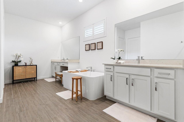 962 Castaway Ct, Loxahatchee, FL 33470 - full bath with wood finished floors, a freestanding bath, recessed lighting, and two vanities
