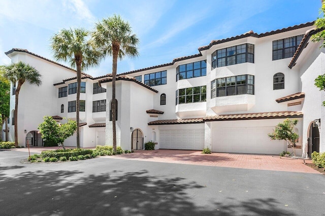 4401 N Ocean Blvd Unit 12, Boca Raton, FL 33431 - mediterranean / spanish-style home featuring stucco siding, a garage, decorative driveway, and a tiled roof