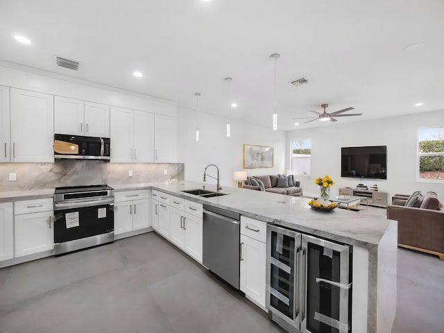 7285 Via Luria, Lake Worth, FL 33467 - kitchen featuring a sink, wine cooler, stainless steel appliances, and open floor plan