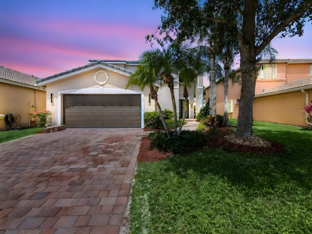 7285 Via Luria, Lake Worth, FL 33467 - view of front of house with a yard, a tiled roof, decorative driveway, an attached garage, and stucco siding