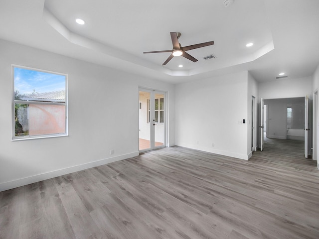 7285 Via Luria, Lake Worth, FL 33467 - interior space featuring recessed lighting, a ceiling fan, a tray ceiling, baseboards, and light wood-style floors
