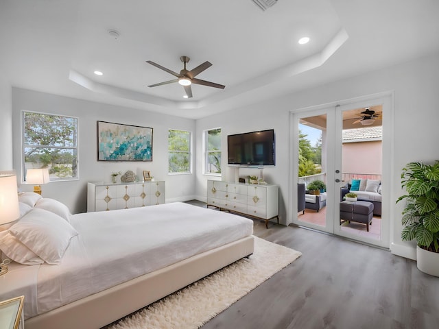 7285 Via Luria, Lake Worth, FL 33467 - bedroom featuring french doors, wood finished floors, recessed lighting, a raised ceiling, and access to exterior