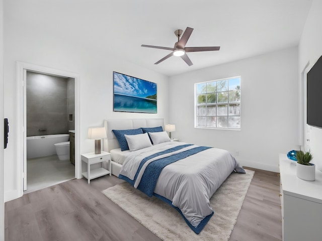7285 Via Luria, Lake Worth, FL 33467 - bedroom featuring ceiling fan, ensuite bathroom, and wood finished floors