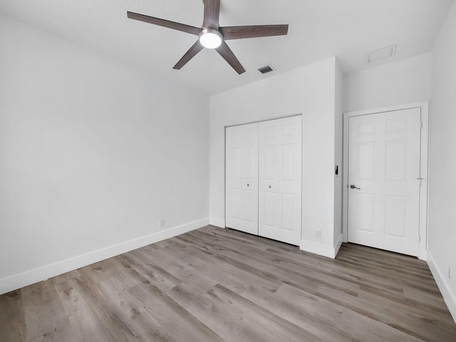 7285 Via Luria, Lake Worth, FL 33467 - unfurnished bedroom featuring a closet, visible vents, wood finished floors, and baseboards