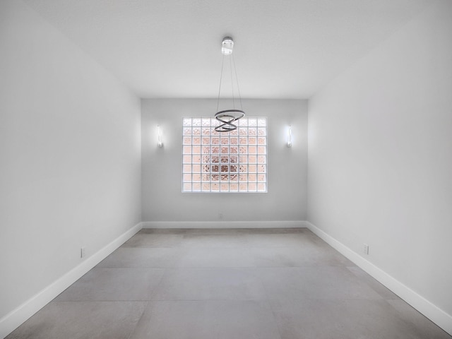 7285 Via Luria, Lake Worth, FL 33467 - unfurnished dining area featuring baseboards, an inviting chandelier, and finished concrete floors
