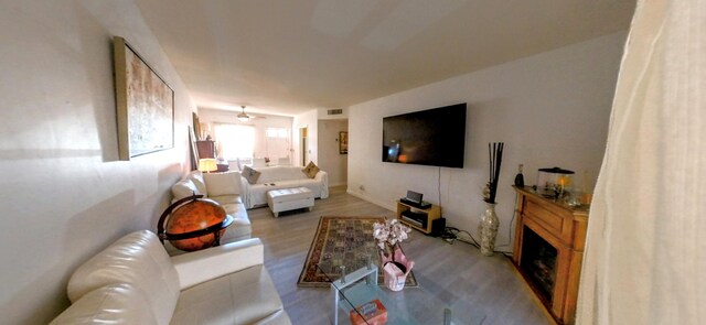 living room with wood finished floors and a fireplace