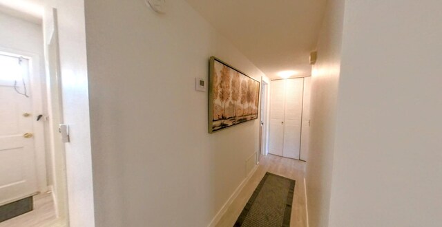 corridor featuring light wood-style floors